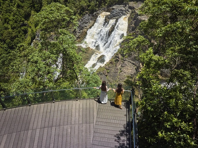 Two women stand at the glass railing overlooking Barron falls