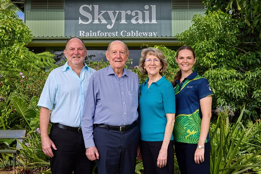 Left to right: Ken Chapman, George Chapman, Karen Hawkins and Emily Chapman stand in front of large Skyrail Rainforest Cableway sign